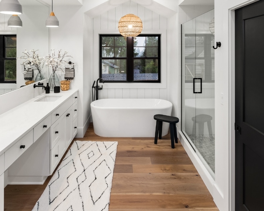 Image depicts a modern bathroom with hardwood floors.