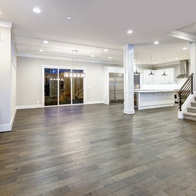 Image depicts a basement with newly installed Canadian hard maple hardwood floors.