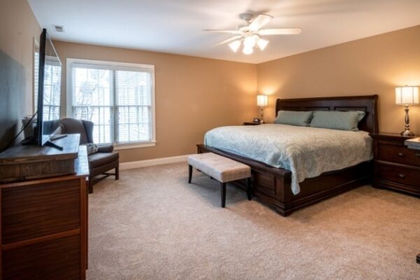 Image depicts a hotel room with newly installed carpet flooring.