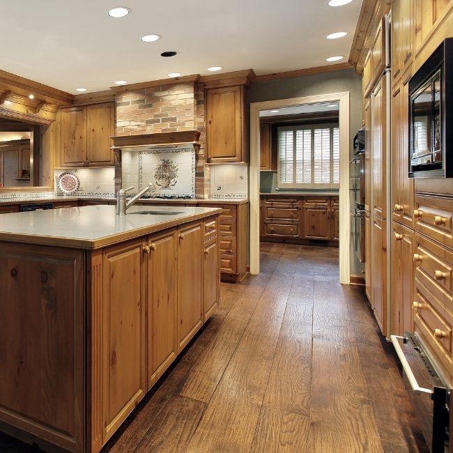 Image depicts a kitchen with newly installed hickory hardwood floors.