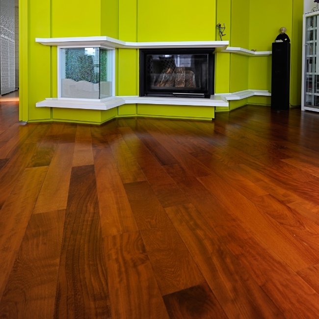 Image depicts a living room with newly installed Brazilian Cherry (Jatoba) hardwood floors.