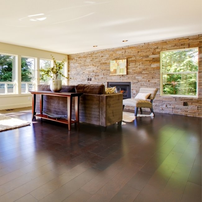 Image depicts a living room with newly installed exotic walnut hardwood floors.