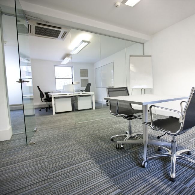 Image depicts an office space with new carpets from Flooring Liquidators.
