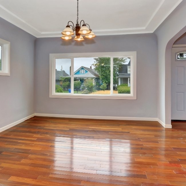 Image depicts a living room with newly installed tigerwood hardwood floors.