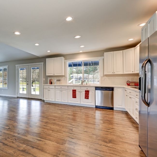 Image depicts a kitchen in an Ottawa home with new laminate floors.