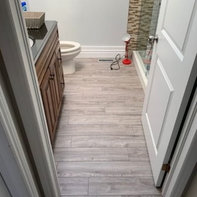 Image depicts a laminate flooring installation project in Mississauga by Flooring Liquidators.