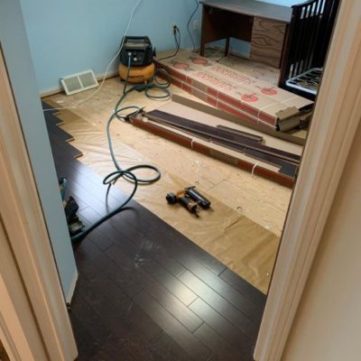 Image depicts a solid hardwood flooring installation project by Flooring Liquidators in London, Ontario.