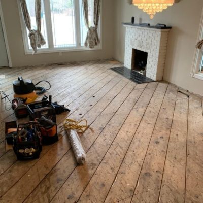 Image depicts a solid hardwood flooring installation project in London, Ontario.