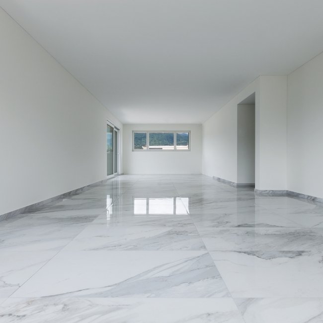 Image depicts the interior of a condo in Hamilton with newly installed white tile floors.