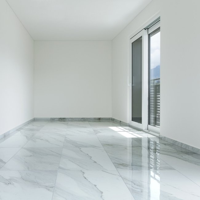 Image depicts the interior of a condo in London with newly installed tile floors.