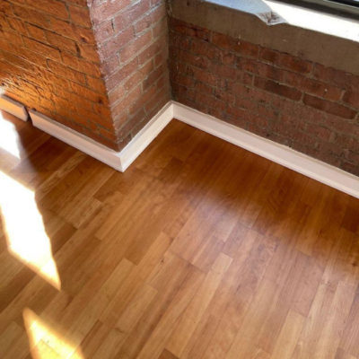 Image depicts old floors from an engineered hardwood flooring installation project in Toronto, Ontario.