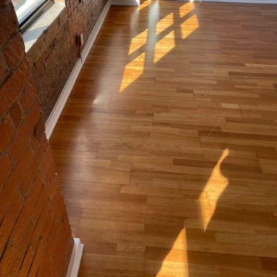Image depicts old floors from an engineered hardwood flooring installation project in Toronto, Ontario.