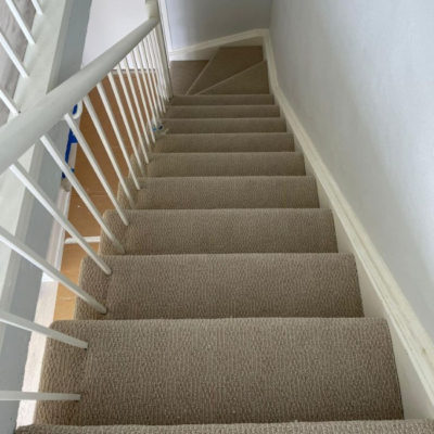 Image depicts new stairs from a laminate and carpet flooring installation project in Toronto, Ontario.