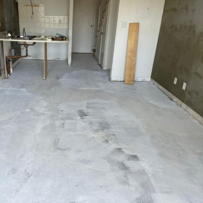 Image depicts old floors from a laminate and carpet flooring installation project in Toronto, Ontario.