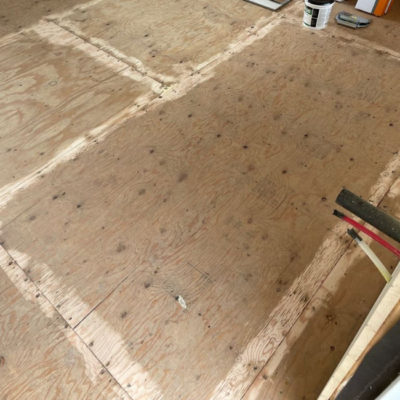 Image depicts old floors from a loose lay vinyl flooring installation project in London, Ontario.