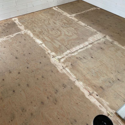 Image depicts old floors from a loose lay vinyl flooring installation project in London, Ontario.