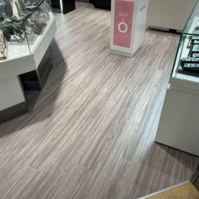 Image depicts new floors from a commercial loose lay vinyl glue down flooring installation project in Brampton, Ontario.