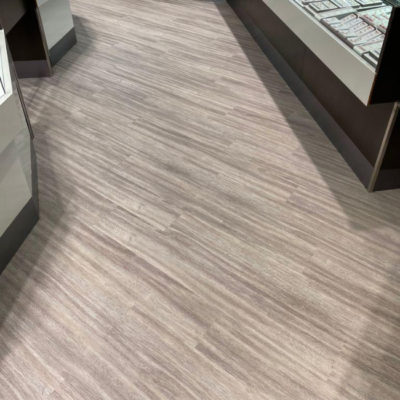 Image depicts new floors from a commercial loose lay vinyl glue down flooring installation project in Brampton, Ontario.