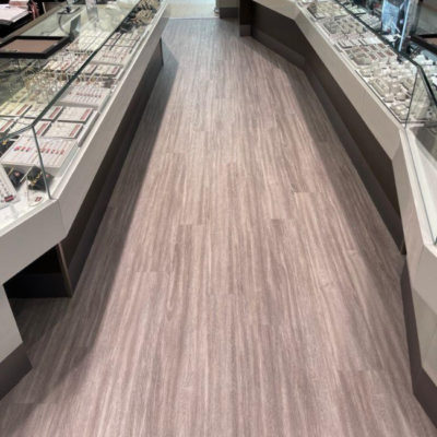 Image depicts new floors from a commercial loose lay vinyl glue down flooring installation project in Brampton, Ontario.