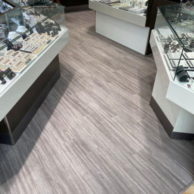 Image depicts new floors from a commercial loose lay vinyl glue down flooring installation project in Brampton, Ontario.
